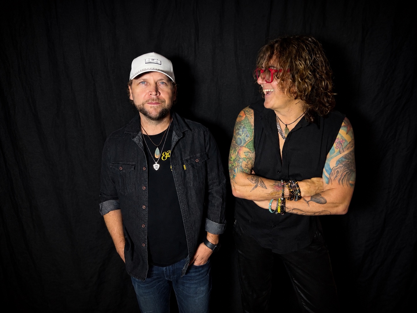 Steven Jasik and Brian Salmon of Jet Lag Motel posing against a black backdrop